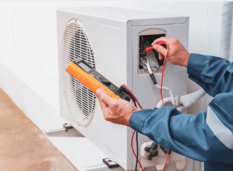 Technician testing an HVAC control circuit with a multimeter